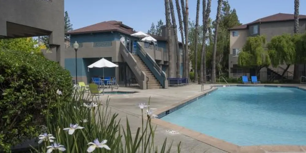 Outdoor swimming pool and courtyard at Sharps Flats student apartments in Davis, CA